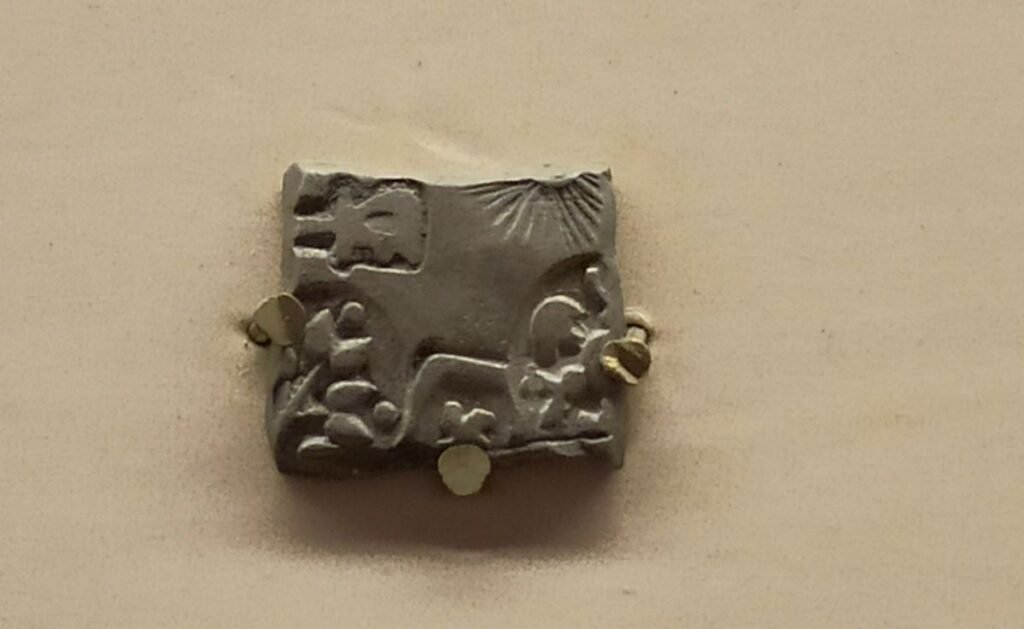 Punch-marked coins of ancient India, representative of the monetary world in which the Mauryan Empire operated.