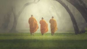 three-monks-walking-park
