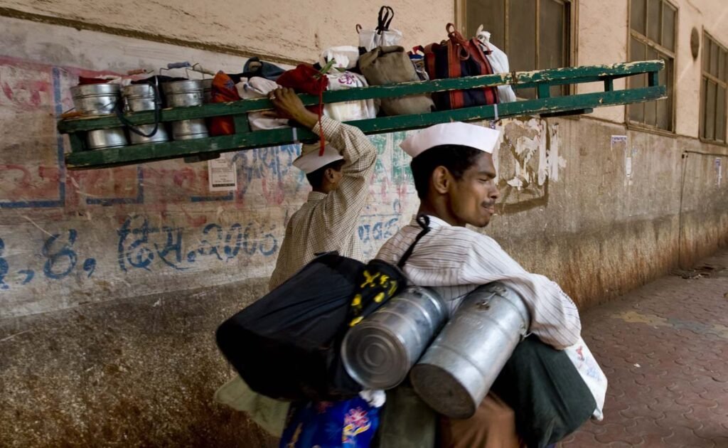Mumbai dabbawalas handling tiffin containers.