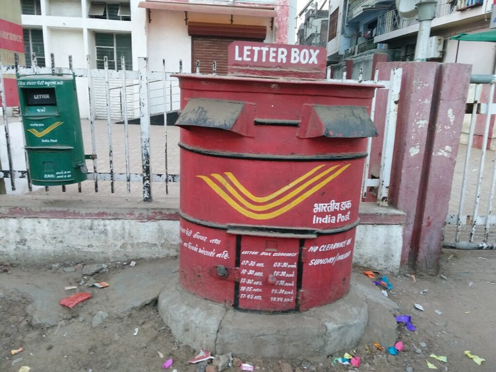 Red India Post letterbox at a post office in Gujarat.