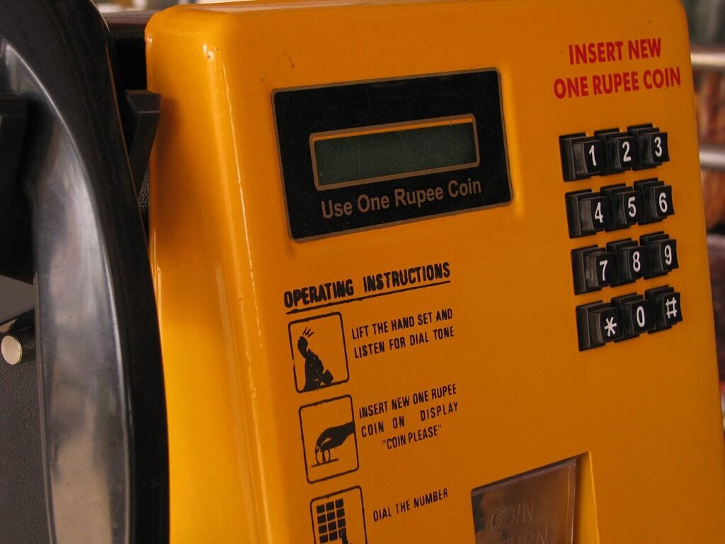 Public payphones and STD PCO signage in India.
