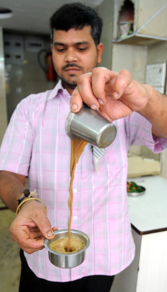 Steel serving vessel of South Indian filter coffee at an Udipi eating house.